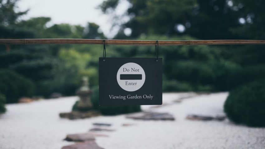 Peaceful garden scene with 'Do Not Enter' sign, promoting serenity and exclusivity.